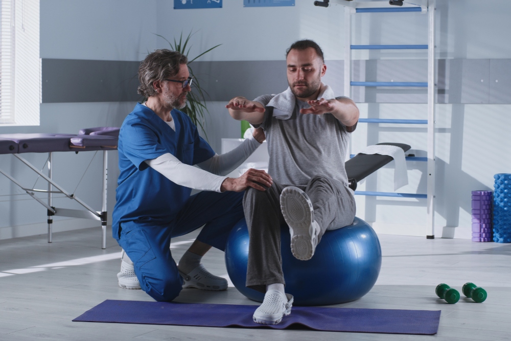 A male patient receiving Kulpsville concussion rehab treatment from a physical therapist.