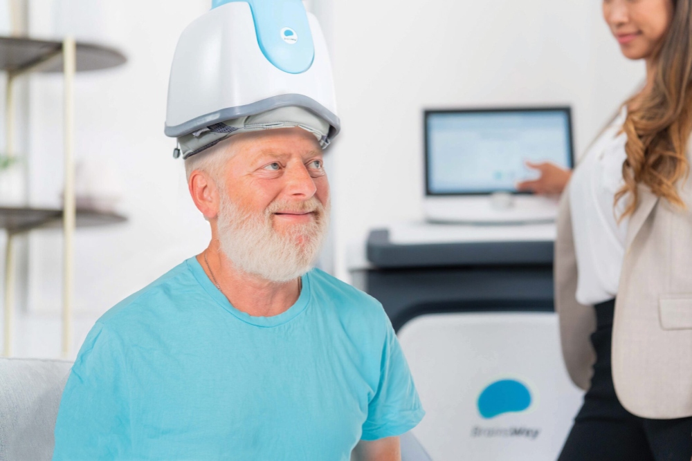 A male patient with TMS therapy helmet on as part of smoking cessation treatment near Penllyn, Blue Bell, Pennsylvania.